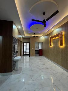 a large room with a ceiling fan and a sink at Independent House, 2 Bedroom, 2 Bath Livingroom,Lobby,kitchen,car parking in Amritsar