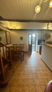 a living room with a table and a dining room at Gîte familial "La montagne des vaches" in Saint-Antoine +22 photos