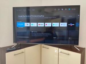 a large flat screen tv sitting on top of cabinets at Villa Radic in Poljica