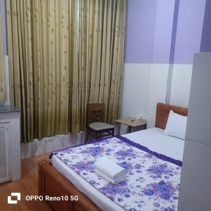 a bedroom with a bed with a laptop on it at Hotel Phương Linh 360 phạm hùng in Ho Chi Minh City