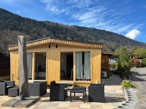 a small house with a mountain in the background at Cozy 2-Bedroom Bungalow in Interlaken