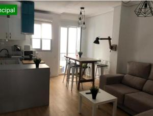a living room with a couch and a table at APARTAMENTO en CENTRO HISTORICO in Murcia
