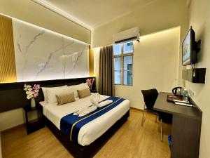 a hotel room with a bed and a desk at Central City Hotel at Chinatown in Kuala Lumpur +44 photos