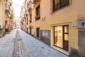 an empty street in an alley between buildings at Family JC in Cagliari