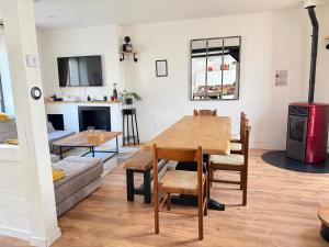 a living room with a table and a couch at Villa de charme avec piscine privée in Ouzouer-sur-Loire +21 photos