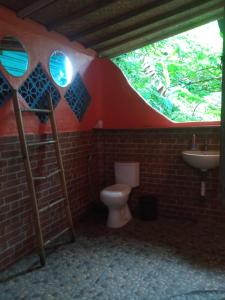 a bathroom with a toilet and a sink at Ubud Jungle River in Ubud
