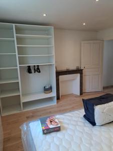 a room with a bed and a book on a table at Au petit st Emiland in Saint-Émiland