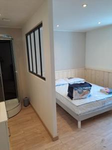 a room with a bed in a room with a window at Au petit st Emiland in Saint-Émiland