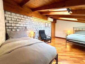 a bedroom with a bed and a brick wall at Casa Lory in Bellagio +45 photos