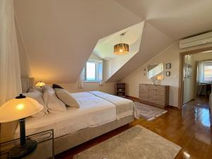 a bedroom with a large white bed in a attic at House Bianca Brac - New Listing - Experienced host in Postira