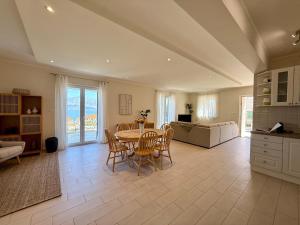 a large living room with a table and chairs at House Bianca Brac - New Listing - Experienced host in Postira