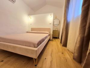 a small bedroom with a bed and a window at Romantica Corte dei limoni Piscinas in Piscinas +11 photos