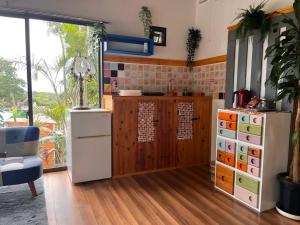 a kitchen with a white refrigerator and a counter at Buena Vista Villa Amami in Amami