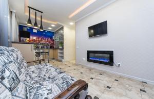 a living room with a couch and a fireplace at Luxury Apartment near ТЦ Україна in Kyiv