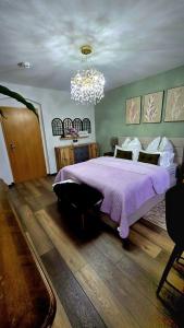 a bedroom with a large bed and a chandelier at Cozy Pet-Friendly Apartment in Meißen