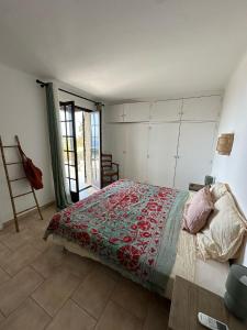 a bedroom with a bed and a large window at A Hilltop Haven in Lumio - Sea View and Cascading Terraces in Lumio +48 photos
