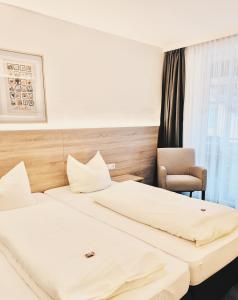 Postel nebo postele na pokoji v ubytování Hotel Garni Brugger + 17 fotografií