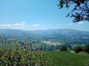 a view of a valley with mountains in the distance at El Mirador de Abionzo in Abionzo +6 photos