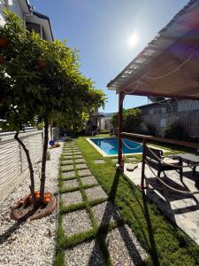 a garden with two trees and a swimming pool at Villa Dalaman Müjgan Hanım Konağı in Dalaman +16 photos