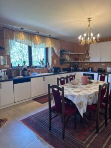 a kitchen with a table with chairs and a dining room at Siedlisko Agata in Drohiczyn +9 photos