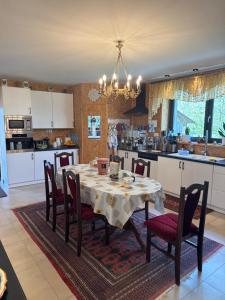 a kitchen with a table and chairs in a kitchen at Siedlisko Agata in Drohiczyn