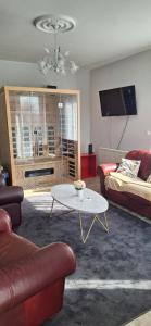 a living room with a couch and a coffee table at Wellrest Nature Vendégház in Hegymagas