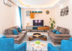ein Wohnzimmer mit Sofas und einem Flachbildfernseher in der Unterkunft Öztürk Farm House in Samsun