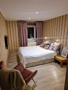 a bedroom with two beds and a chair at Cosy apartment in Padise in Padise +10 photos