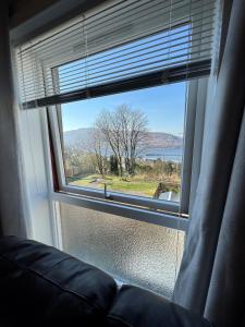 a window with a couch looking out at a view at House in Fort William in Fort William +18 photos