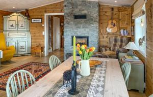 a living room with a wooden table and a fireplace at Gorgeous Home In Oppdal With Wifi in Oppdal