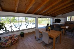a living room with a wooden table and chairs at Villa Nirvana in Mostar +43 photos