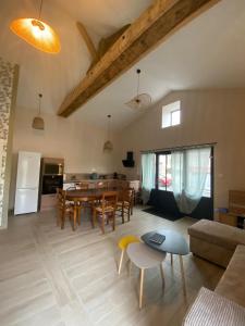 a living room with a table and a dining room at La grange des Arondes in Les Magnils-Reigniers +9 photos