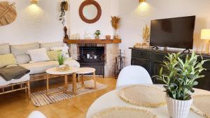 a living room with a couch and a fireplace at La Casita Denia, charming 2BR Townhouse with shared Pool, 1km to Beach in Els Poblets