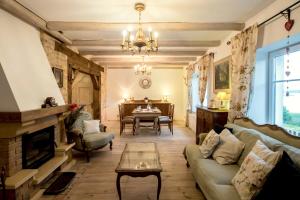 a living room with a couch and a fireplace at Dom pod Skrzydłami in Gawliki Wielkie