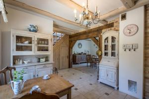 a kitchen with a table and a dining room at Dom pod Skrzydłami in Gawliki Wielkie