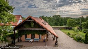 a pavilion with a table and chairs in a garden at Dom pod Skrzydłami in Gawliki Wielkie