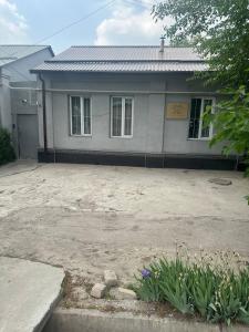 a house with a large driveway in front of it at Family hostel Toshkent in Toshkent-Passajir Bekati