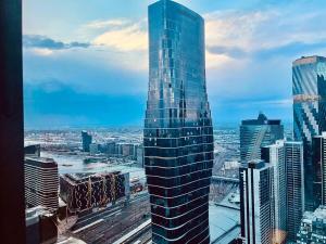 a tall glass building in a large city at Stylish High-Rise City Retreat in front of Southern Cross in Melbourne