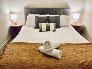 a bedroom with a large bed with towels on it at Stylish High-Rise City Retreat in front of Southern Cross in Melbourne +30 photos