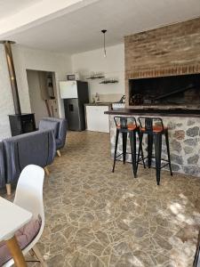 a kitchen and a living room with a table and chairs at La Juliet in Colonia del Sacramento