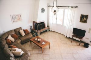 a living room with a couch and a coffee table at Villa Melivia in Hersonissos