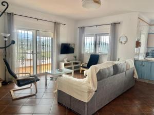 salon z kanapą i krzesłem w obiekcie Casa rural Villa Miradri w mieście Torrox