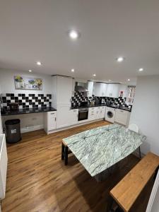 a large kitchen with a table in the middle of it at Lupin Cottage Hot Tub Hide Out Dog Friendly in Weymouth