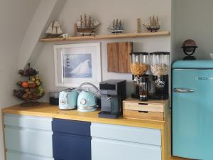 a kitchen with a counter with a blue refrigerator at Les pieds dans l'eau in Saint Malo
