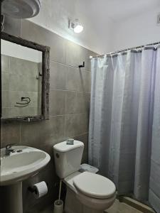 a bathroom with a white toilet and a sink at La Juliet in Colonia del Sacramento +13 photos