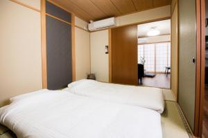 a bedroom with two beds in a room at Yaoyorozu Modern Inn in Kyoto