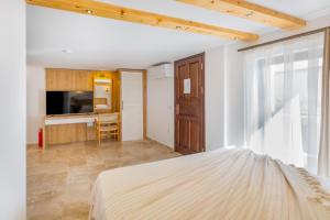 een slaapkamer met een bed en een bureau bij White Garden Villas Studio Patara in Kas