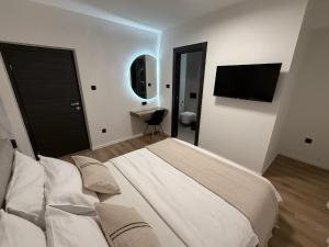 a bedroom with a large bed and a television at Villa Barbara in Split