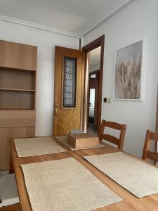 a room with a table and chairs and a door at Ático Jovellanos in Gijón +10 photos
