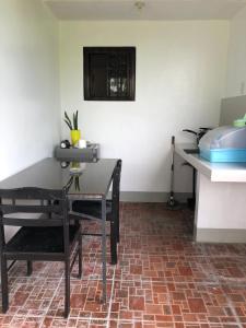 a dining room with a table and a chair at Roof Deck Suite at Matildes Sanctuary in Dampol